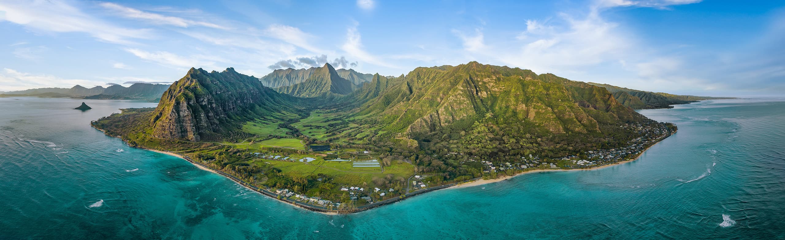 Aerial panorama of Oahu's windward coast with Ko'olau mountains and turquoise ocean