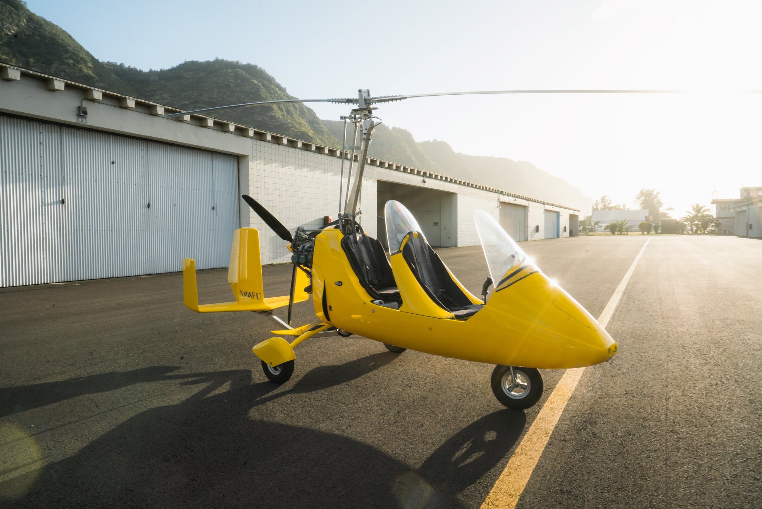 Gyroplane flying open-cockpit over Oahu's North Shore reef