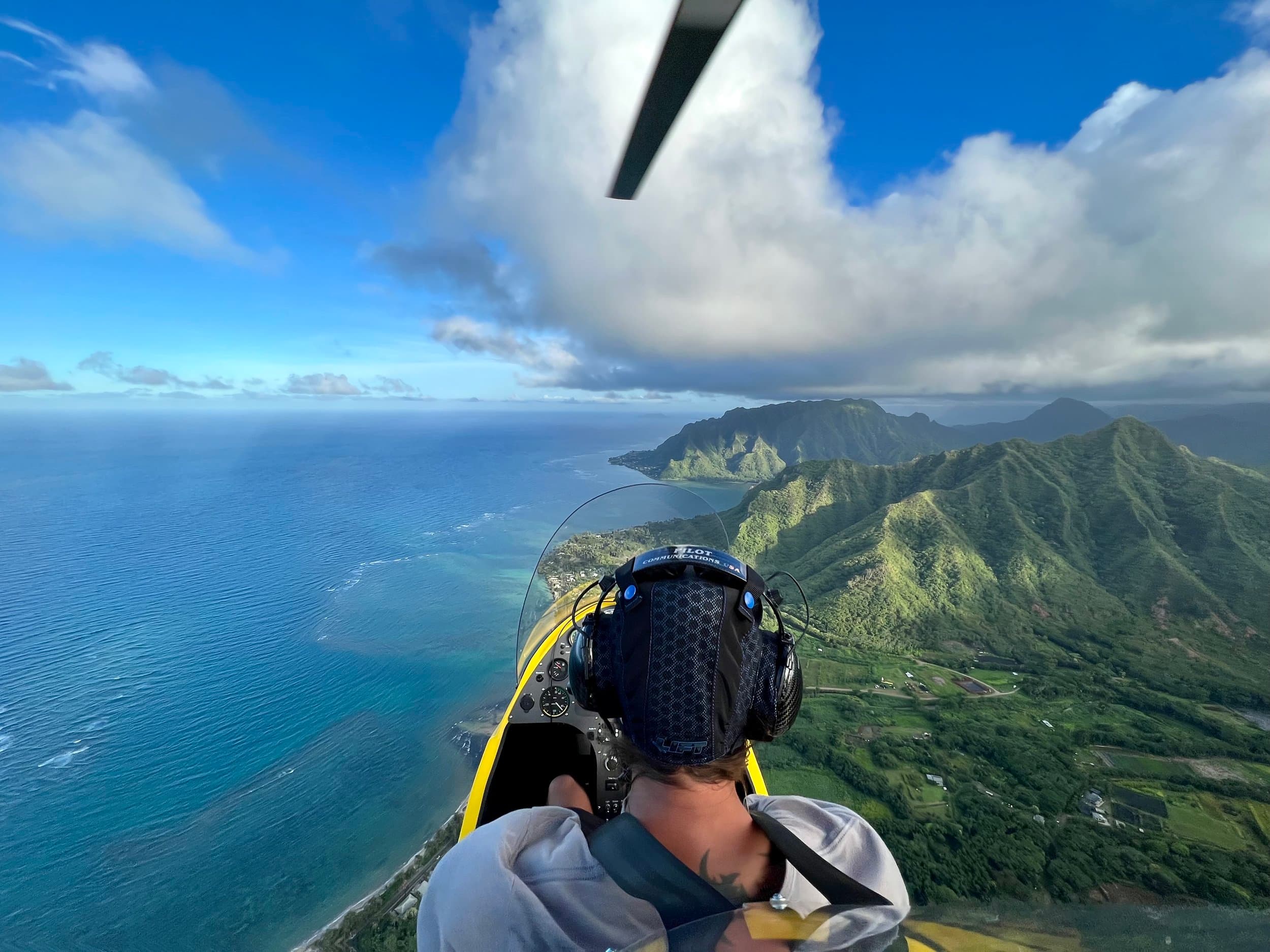 Gyroplane flying open-cockpit over Oahu's North Shore