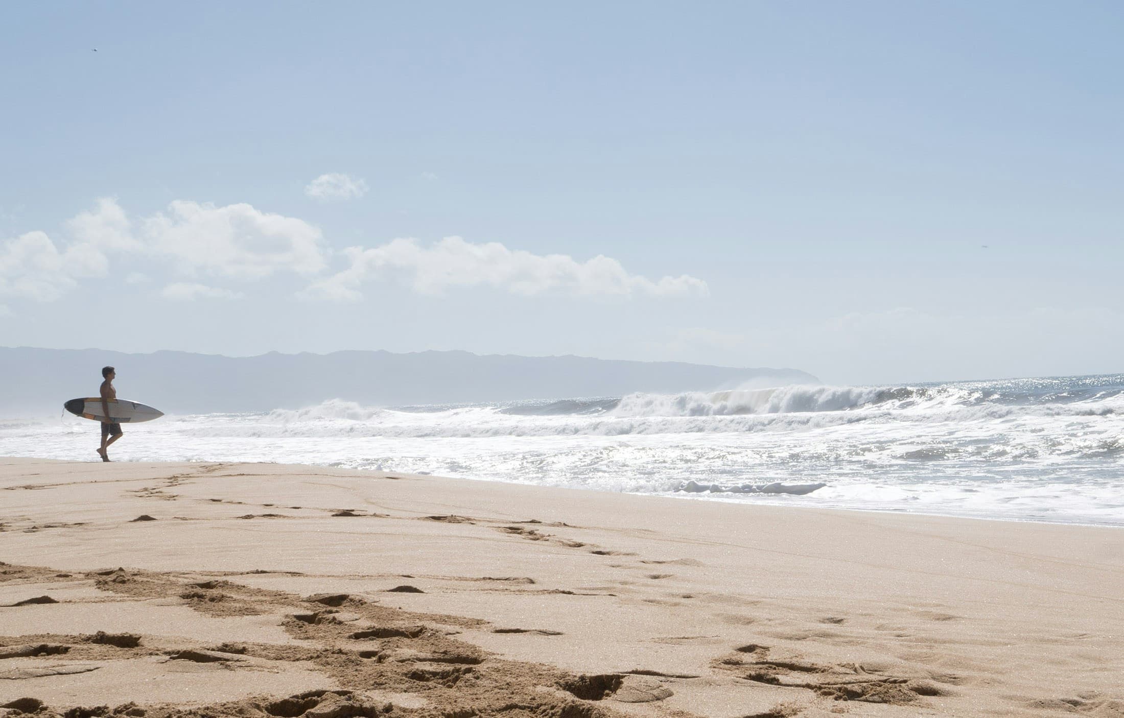 Oahu's North Shore coastline with turquoise water and lush green mountains